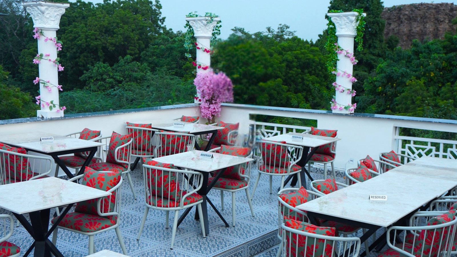 Alora Delhi rooftop dining terrace with white pillars