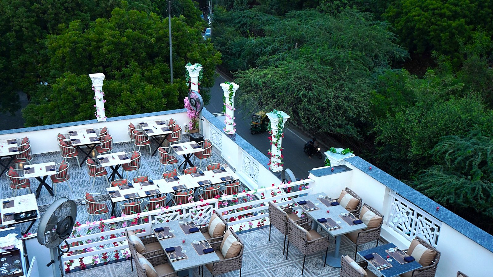Set dining tables on the Alora Delhi rooftop terrace